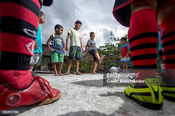 Children of Vila Nova Project, play football on the rooftops in the Morro dos Macacos area on October 26, 2013 in Rio de Janeiro, Brazil. The Project...