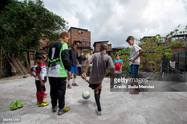 Children of Vila Nova Project, plays football on the rooftops in the Morro dos Macacos area on October 26, 2013 in Rio de Janeiro, Brazil. The...