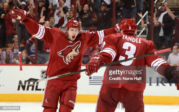 Oliver Ekman-Larsson and teammate Keith Yandle celebrate the game winning goal against the Edmonton Oilers at Jobing.com Arena on October 26, 2013 in...