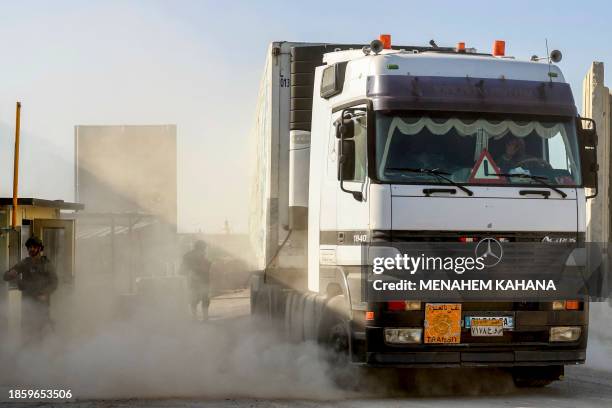 Truck carrying humanitarian aid moves at the Israeli side of the Kerem Shalom border crossing with the southern Gaza Strip on December 19 amid the...