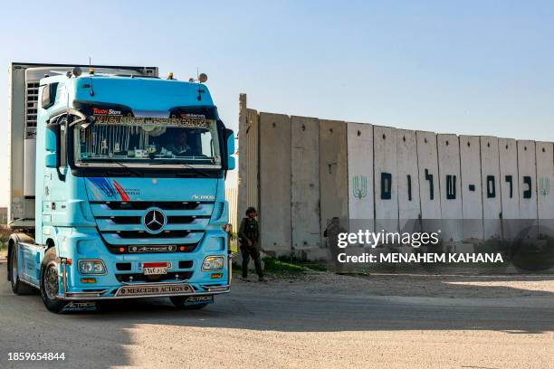 Truck carrying humanitarian aid moves at the Israeli side of the Kerem Shalom border crossing with the southern Gaza Strip on December 19 amid the...