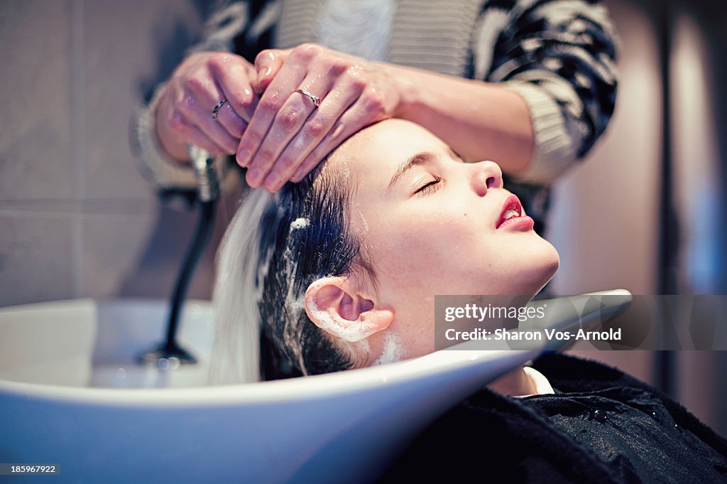 Girl having hair washed at hair salon