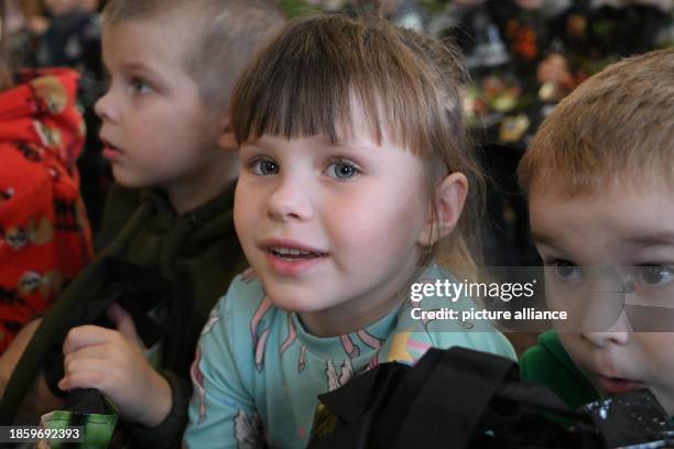 December 2023, Ukraine, Lysa Gora: Ukrainian girls and boys from an orphanage are delighted with Christmas presents brought by the private...