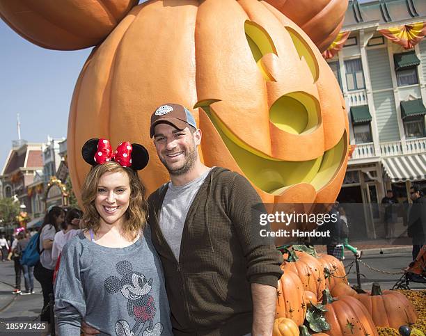 Actress Alyssa Milano of television series"Mistresses" and husband David Bugliari celebrate "Halloween Time" at Disneyland on October 26, 2013 in...