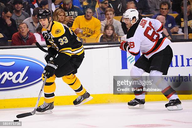 Zdeno Chara of the Boston Bruins skates with the puck against Jaromir Jagr of the New Jersey Devils at the TD Garden on October 26, 2013 in Boston,...