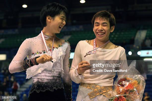 Nobunari Oda of Japan celebrates his bronze medal win with Yuzuru Hanyu of Japan who took the silver in the men's free program on day two at the ISU...