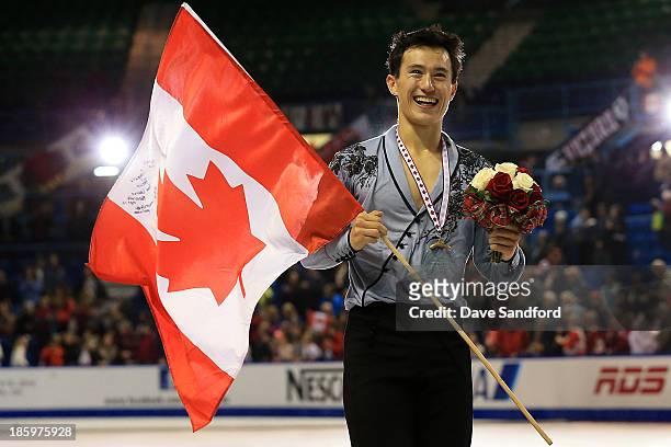 Patrick Chan of Canada celebrates his gold medal victory during the men's free program on day two at the ISU GP 2013 Skate Canada International at...