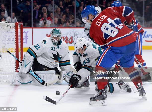 Antti Niemi and Matthew Nieto of the San Jose Sharks protect the net against Lars Eller of the Montreal Canadiens during the NHL game on October 26,...