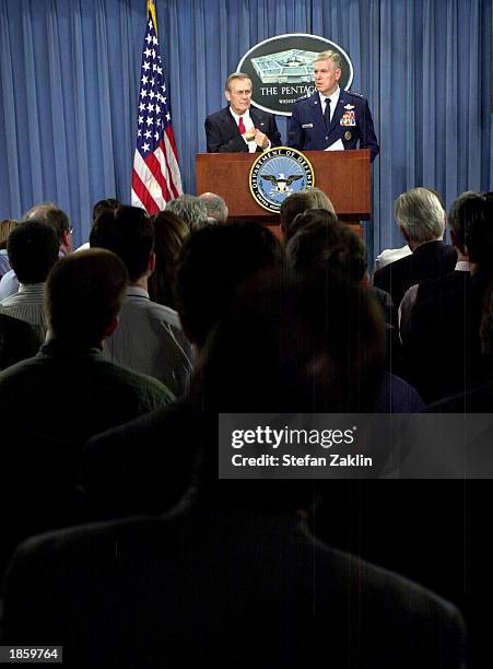 Secretary of Defense Donald Rumsfeld listens as the Chairman of the Joint Chiefs of Staff General Richard Myers speaks at the Pentagon March 20, 2003...