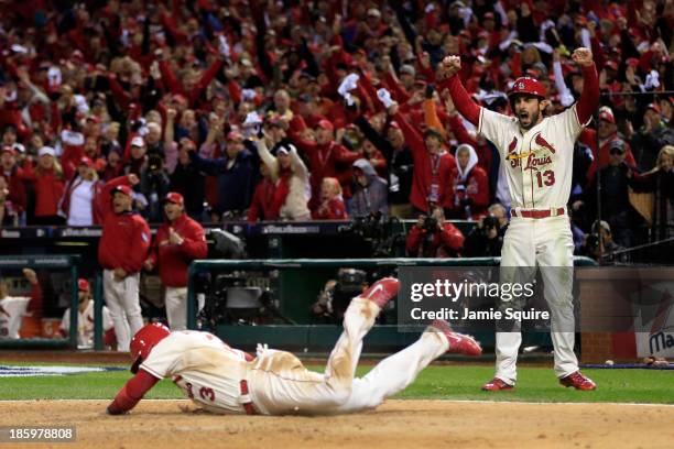 Carlos Beltran of the St. Louis Cardinals and Matt Carpenter celebrate as they score on a double by Matt Holliday in the seventh inning against the...