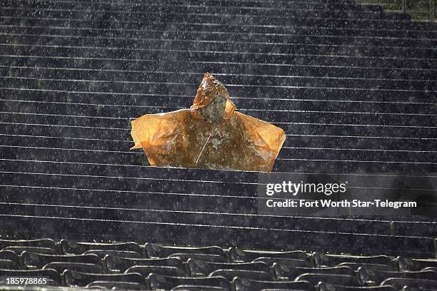 Lone, hardy Texas fan toughs it out during the second-quarter rain delay against Texas Christian at Amon Carter Stadium in Fort Worth, Texas, on...