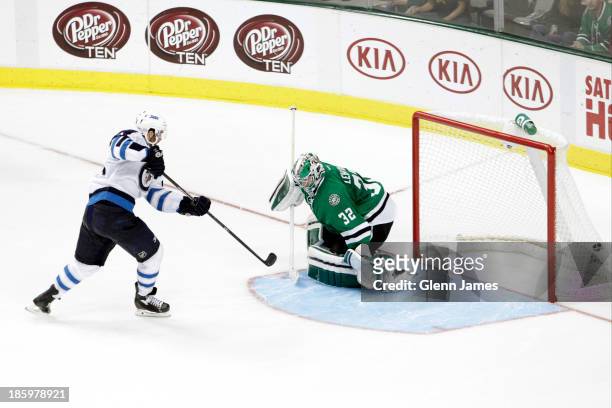Andrew Ladd of the Winnipeg Jets gets a shootout winning goal against Kari Lehtonen of the Dallas Stars at the American Airlines Center on October...
