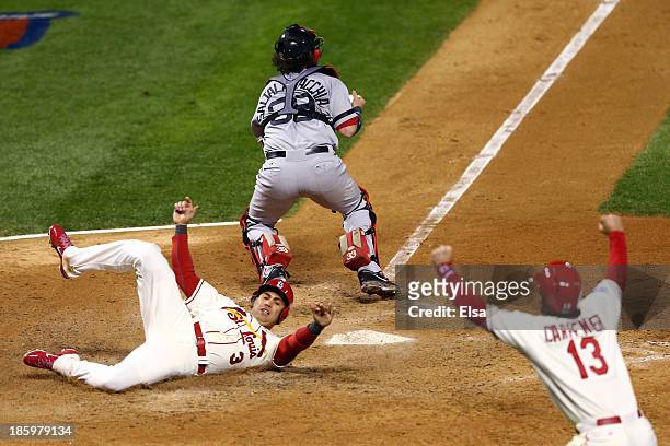 Carlos Beltran of the St. Louis Cardinals and Matt Carpenter celebrate as they score on a double by Matt Holliday in the seventh inning as Jarrod...