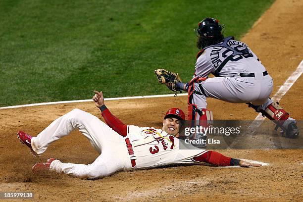 Carlos Beltran of the St. Louis Cardinals slides into home to score on a two RBI double by Matt Holliday as Jarrod Saltalamacchia of the Boston Red...