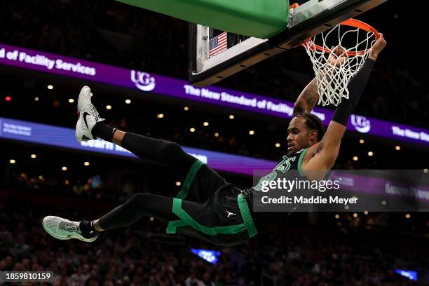 Oshae Brissett of the Boston Celtics hands from the basket after dunking against the Orlando Magic during the second half at TD Garden on December...