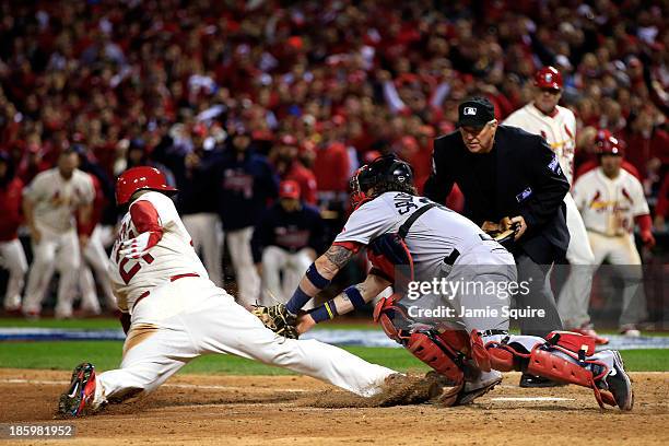 Allen Craig of the St. Louis Cardinals scores on a feilder's choice by Jon Jay in the ninth inning as Jarrod Saltalamacchia of the Boston Red Sox...