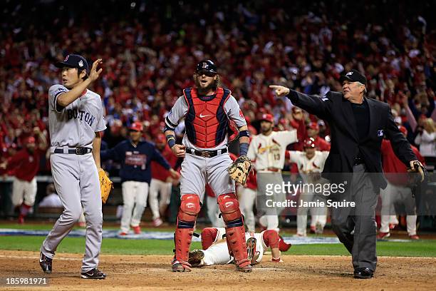 Allen Craig of the St. Louis Cardinals scores on a feilder's choice by Jon Jay in the ninth inning as Jarrod Saltalamacchia and Koji Uehara of the...