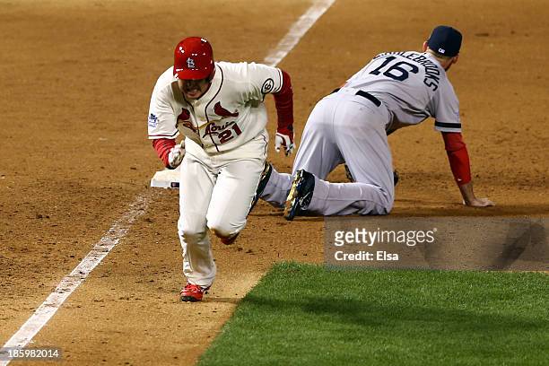 Allen Craig of the St. Louis Cardinals runs after being tripped up by Will Middlebrooks of the Boston Red Sox during the ninth inning of Game Three...