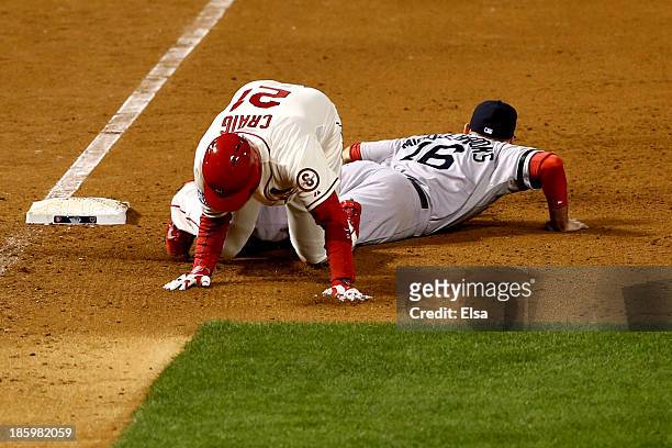 Allen Craig of the St. Louis Cardinals gets tripped up by Will Middlebrooks of the Boston Red Sox during the ninth inning of Game Three of the 2013...