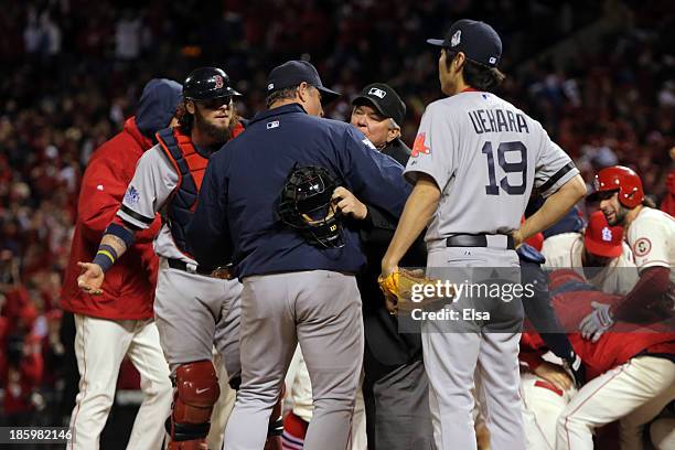 Manager John Farrell and Jarrod Saltalamacchia of the Boston Red Sox argue an obstruction call with Home Plate Umpire Dana DeMuth in the ninth inning...