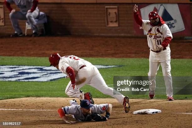 Allen Craig of the St. Louis Cardinals gets tripped up by Will Middlebrooks of the Boston Red Sox during the ninth inning of Game Three of the 2013...