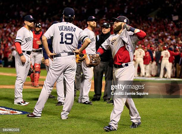 Dustin Pedroia of the Boston Red Sox and others react after Allen Craig of the St. Louis Cardinals scored the winning run in the ninth inning of Game...