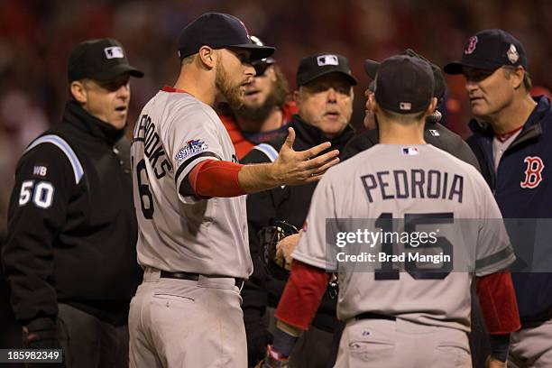 Will Middlebrooks of the Boston Red Sox argues with home plate umpire Dana DeMuth after an obstruction call that led to the St. Louis Cardinals...