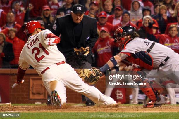 Allen Craig of the St. Louis Cardinals scores on a feilder's choice by Jon Jay in the ninth inning as Jarrod Saltalamacchia of the Boston Red Sox...