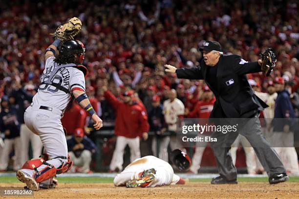 Jarrod Saltalamacchia of the Boston Red Sox reacts as Home Plate Umpire Dana DeMuth calls Allen Craig of the St. Louis Cardinals safe at home in the...