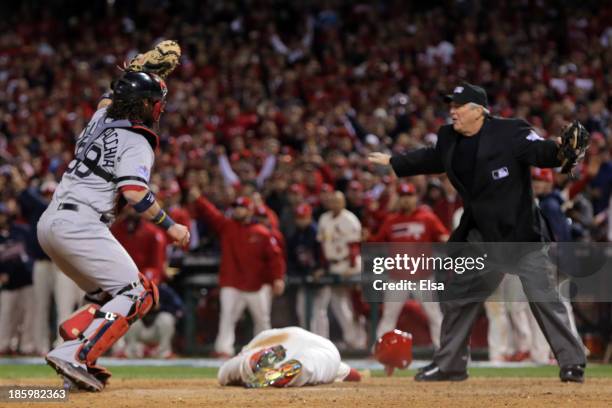 Jarrod Saltalamacchia of the Boston Red Sox reacts as Home Plate Umpire Dana DeMuth calls Allen Craig of the St. Louis Cardinals safe at home in the...