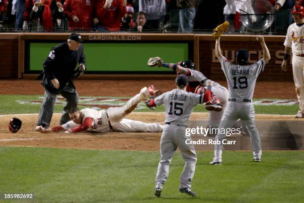 Home plate umpire Dana DeMuth calls Allen Craig of the St. Louis Cardinals safe at home against Jarrod Saltalamacchia of the Boston Red Sox as Dustin...