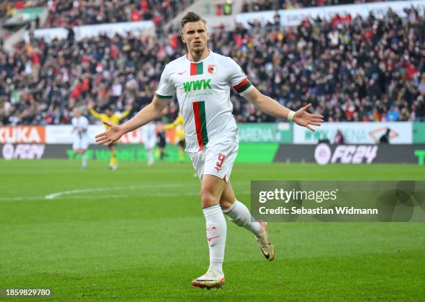 Ermedin Demirovic of FC Augsburg celebrates after scoring their team's first goal during the Bundesliga match between FC Augsburg and Borussia...