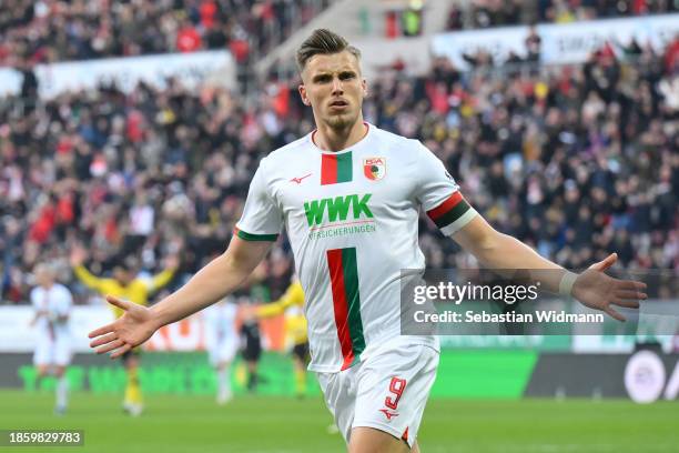 Ermedin Demirovic of FC Augsburg celebrates after scoring their team's first goal during the Bundesliga match between FC Augsburg and Borussia...