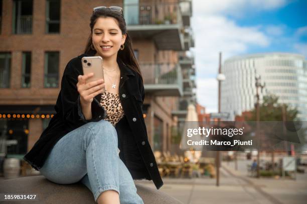 young woman using smartphone relaxing in the city - chilean people stock pictures, royalty-free photos & images