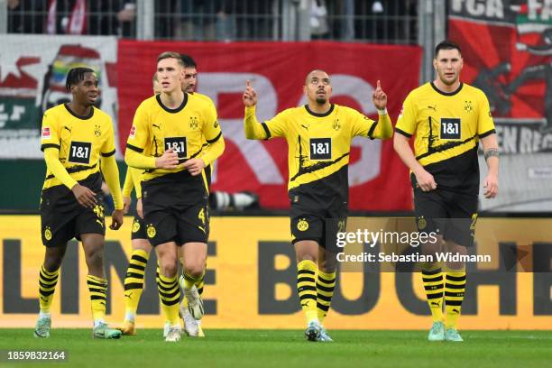 Donyell Malen of Borussia Dortmund celebrates after scoring their team's first goal during the Bundesliga match between FC Augsburg and Borussia...