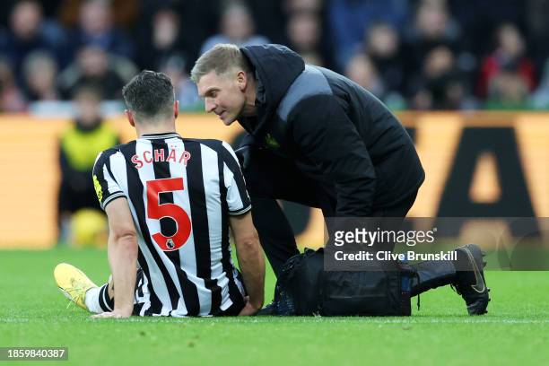 Fabian Schaer of Newcastle United receives treatment before being substituted off injured during the Premier League match between Newcastle United...