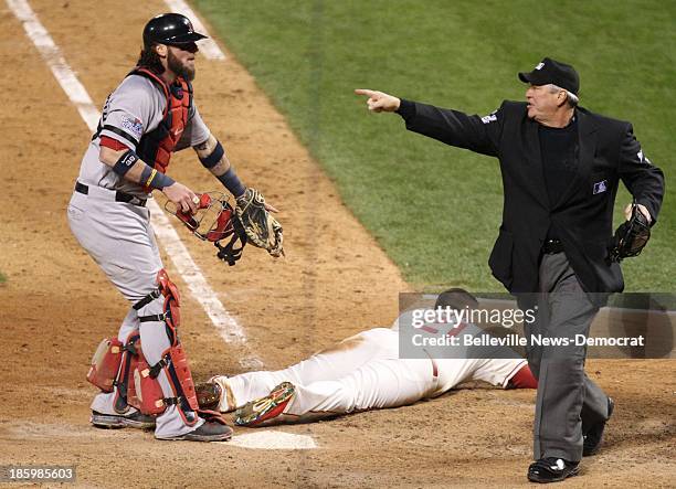 Boston Red Sox catcher Jared Saltalamacchia, left, looks to umpire Dana DeMuth as he indicates an obstruction call at third base as Allen Craig of...