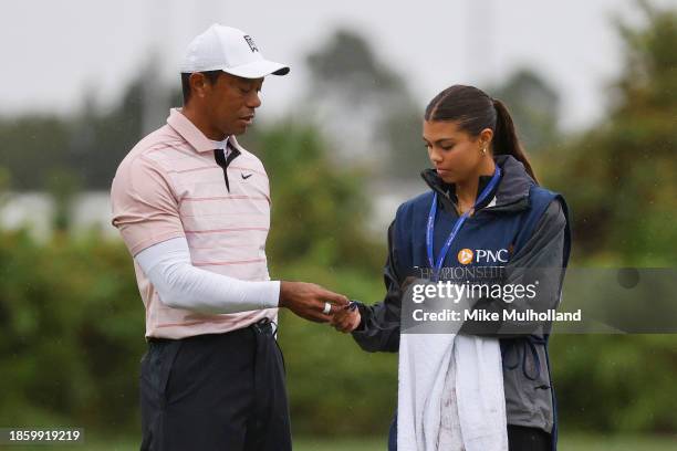 Tiger Woods of the United States and daughter Sam Woods on the third green during the first round of the PNC Championship at The Ritz-Carlton Golf...