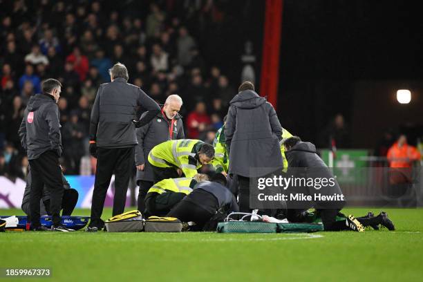 Tom Lockyer of Luton Town receives medical treatment after collapsing during the Premier League match between AFC Bournemouth and Luton Town at...