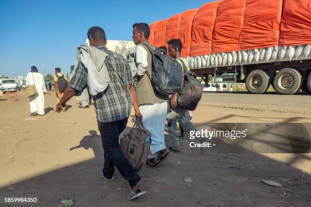 Displaced people fleeing from Wad Madani in Sudan's Jazira state arrive in Gedaref in the country's east on December 19, 2023. Since April 15, Sudan...