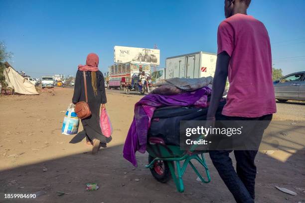 Displaced people fleeing from Wad Madani in Sudan's Jazira state arrive in Gedaref in the country's east on December 19, 2023. Since April 15, Sudan...