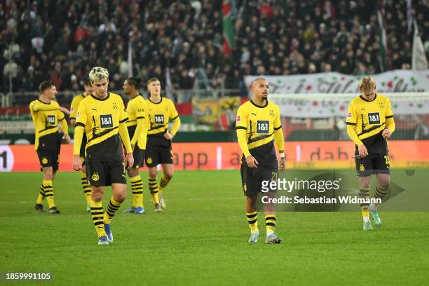 Players of Borussia Dortmund look dejected following the Bundesliga match between FC Augsburg and Borussia Dortmund at WWK-Arena on December 16, 2023...