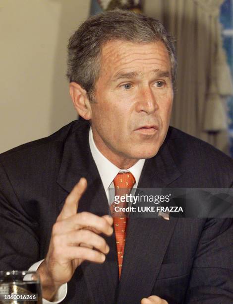 President George W. Bush speaks to reporters 23 October 2001 at a meeting with Congressional leaders at the White House in Washington, DC. Bush...