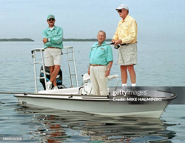 Former US President George H. Bush , accompanied by his long-time angling friend George Hommell and Florida Keys fishing guide Al Polofsky, retrieves...