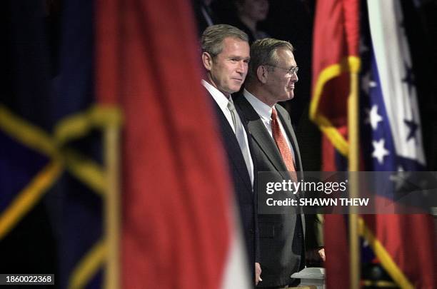 President George W. Bush and Secretary of Defense Donald Rumsfeld watch the colors parade 15 October 2001 during an Armed Forces Welcoming Ceremony...