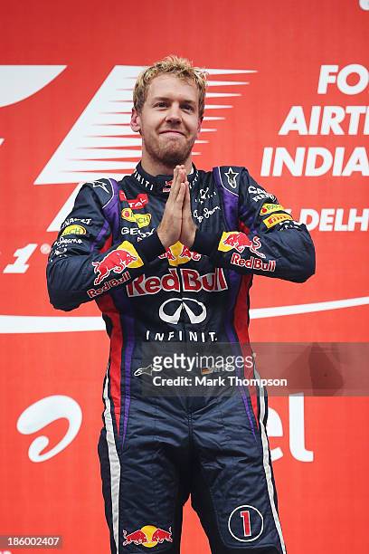 Race winner and 2013 Formula One World Champion Sebastian Vettel of Germany and Infiniti Red Bull Racing celebrates on the podium following the...