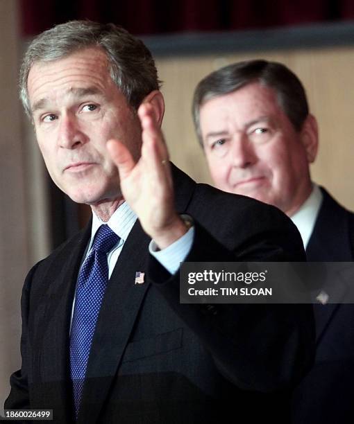 President George W. Bush gestures toward a new list of 22 "most wanted terrorists" sought in connection with attacks on US targets since 1985, as...