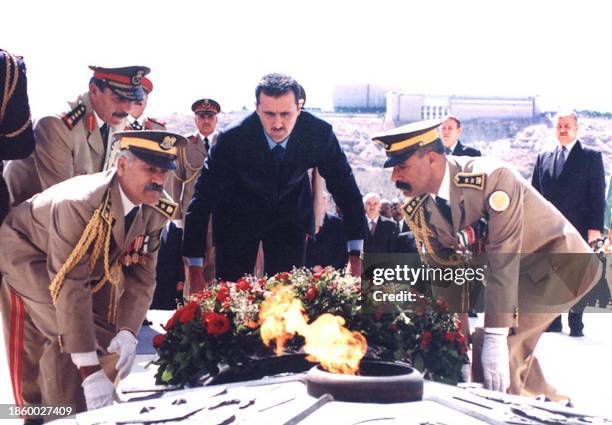 Syrian President Bashar al-Assad lays a wreath at the grave of the unknown soldier 06 October 2001, in Damascus on the 28th anniversary of the 1973...