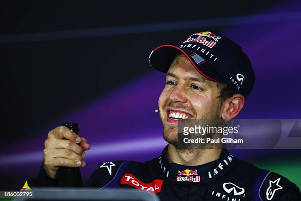 Race winner and 2013 Formula One World Champion Sebastian Vettel of Germany and Infiniti Red Bull Racing celebrates with a drink of champagne in the...