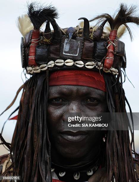 Traditional Ivorian Dozo hunter poses for the photographer on September 27, 2013 in Kani, in the Seguela department 592km from Abidjan, after a...